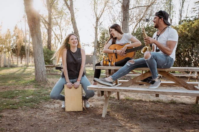 Cheerful musicians having fun in park
