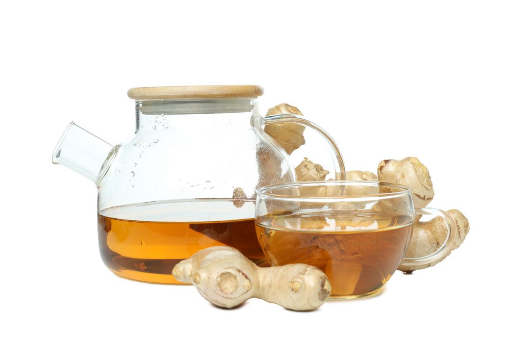cup and teapot with tea, ginger, isolated on plain background