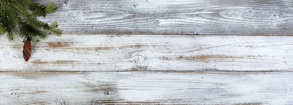 Christmas decoration with fir branch on aged wood setting