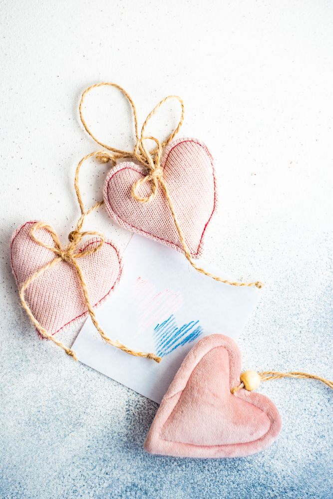 Valentine Day holiday card concept with felt pink heart decorations
