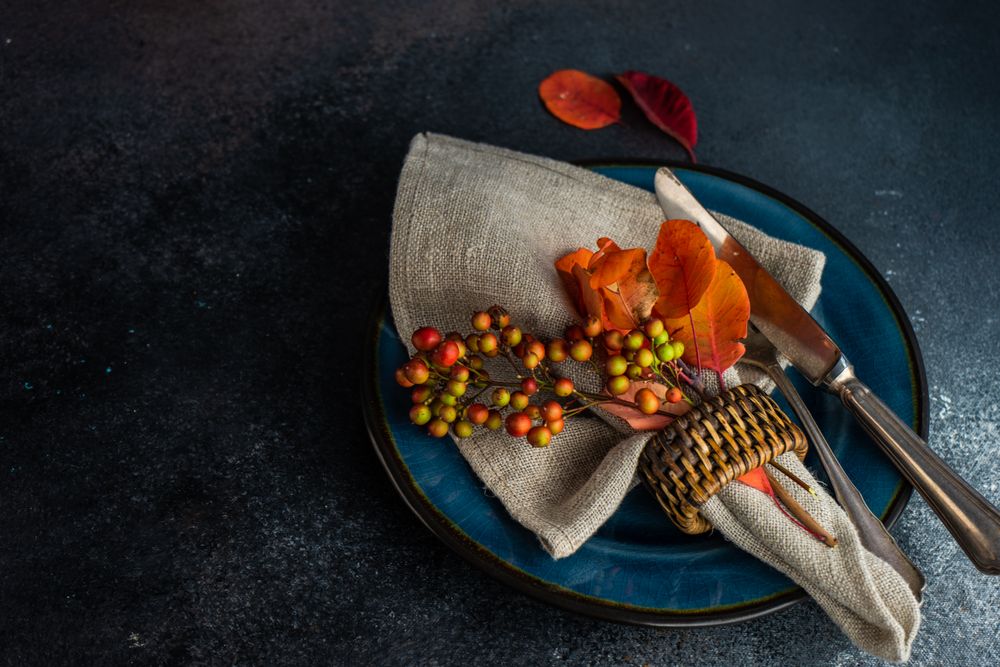 Fall table setting with orange leaves