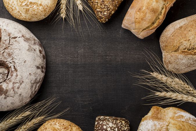 Assortment bread loaves circling a wooden board