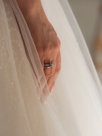 Delicate details of the wedding celebration. Newlyweds hold hands.