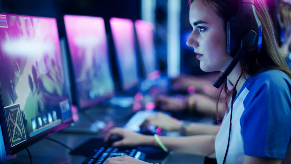 Professional Gamer Plays in MMORPG/ Strategy Video Game on Her Computer.