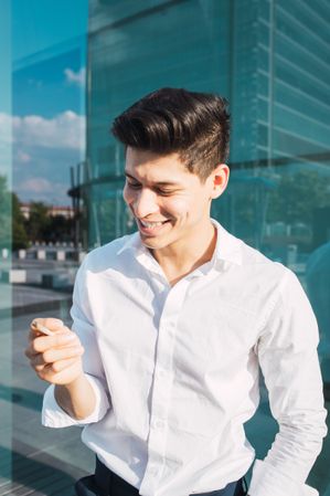 Handsome young man smoking cigarette