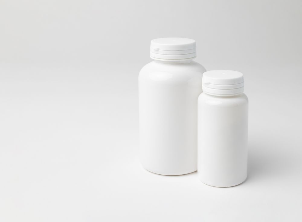 Mockup of two closed plastic medicine bottles, with copyspace, perfect for design mockups