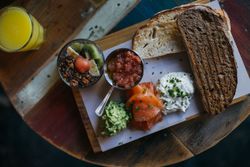Top view of breakfast plate with lox and fruit