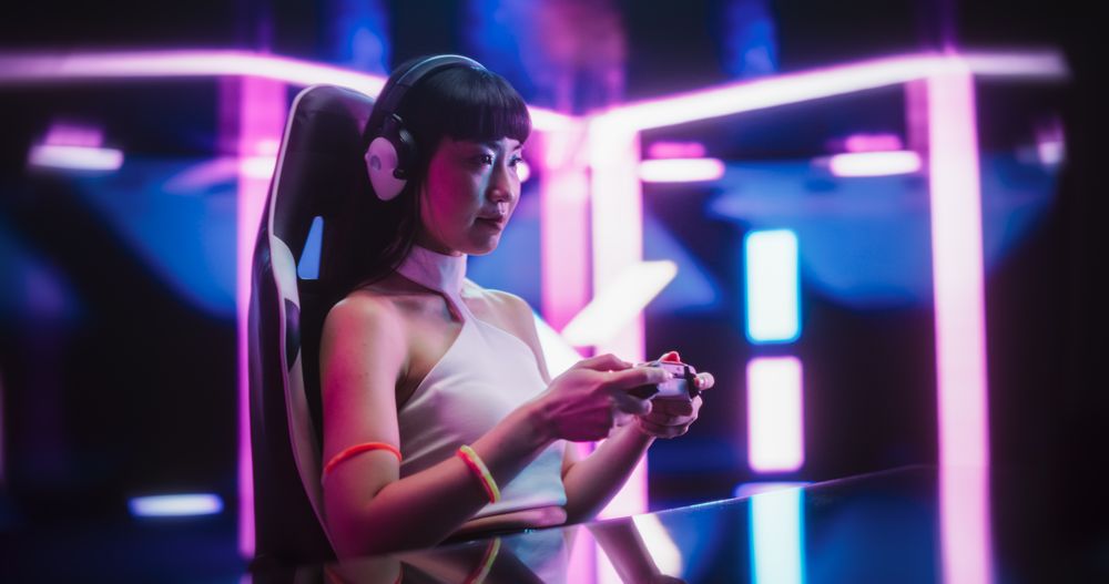 Japanese Female Playing Online Street Racing Simulator on a Computer.