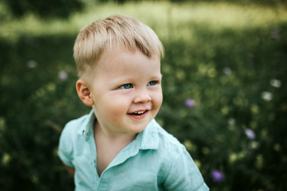 Boy in green shirt smiling