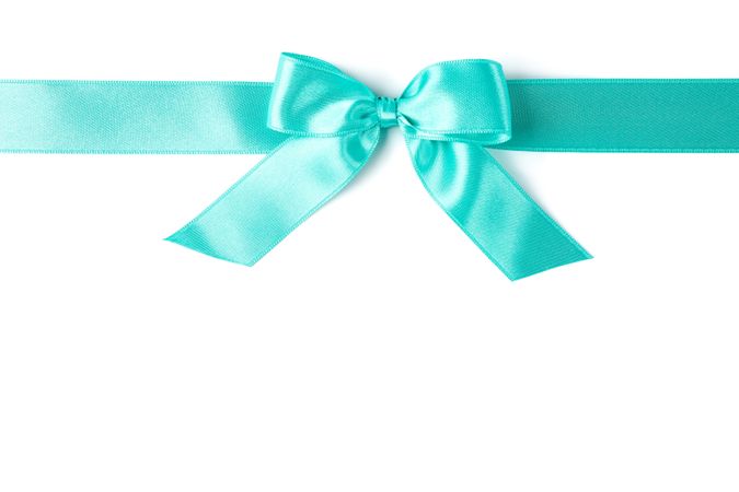 Turquoise ribbon with bow isolated on plain background. Gift concept