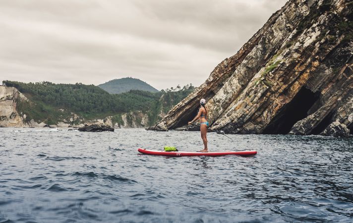 Woman on paddleboard floating in sea