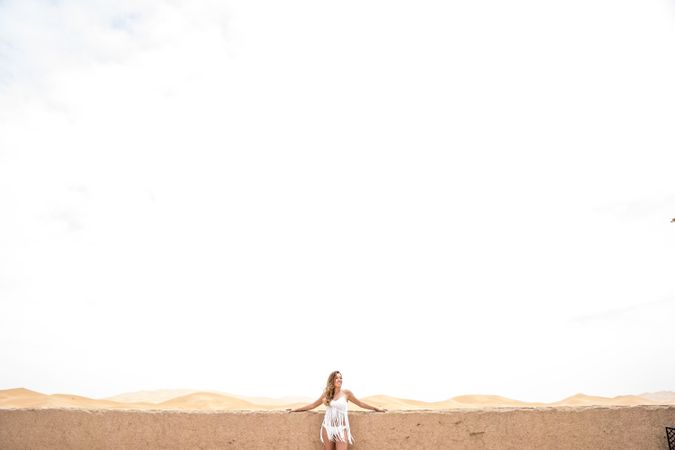 Woman on terrace against desert landscape