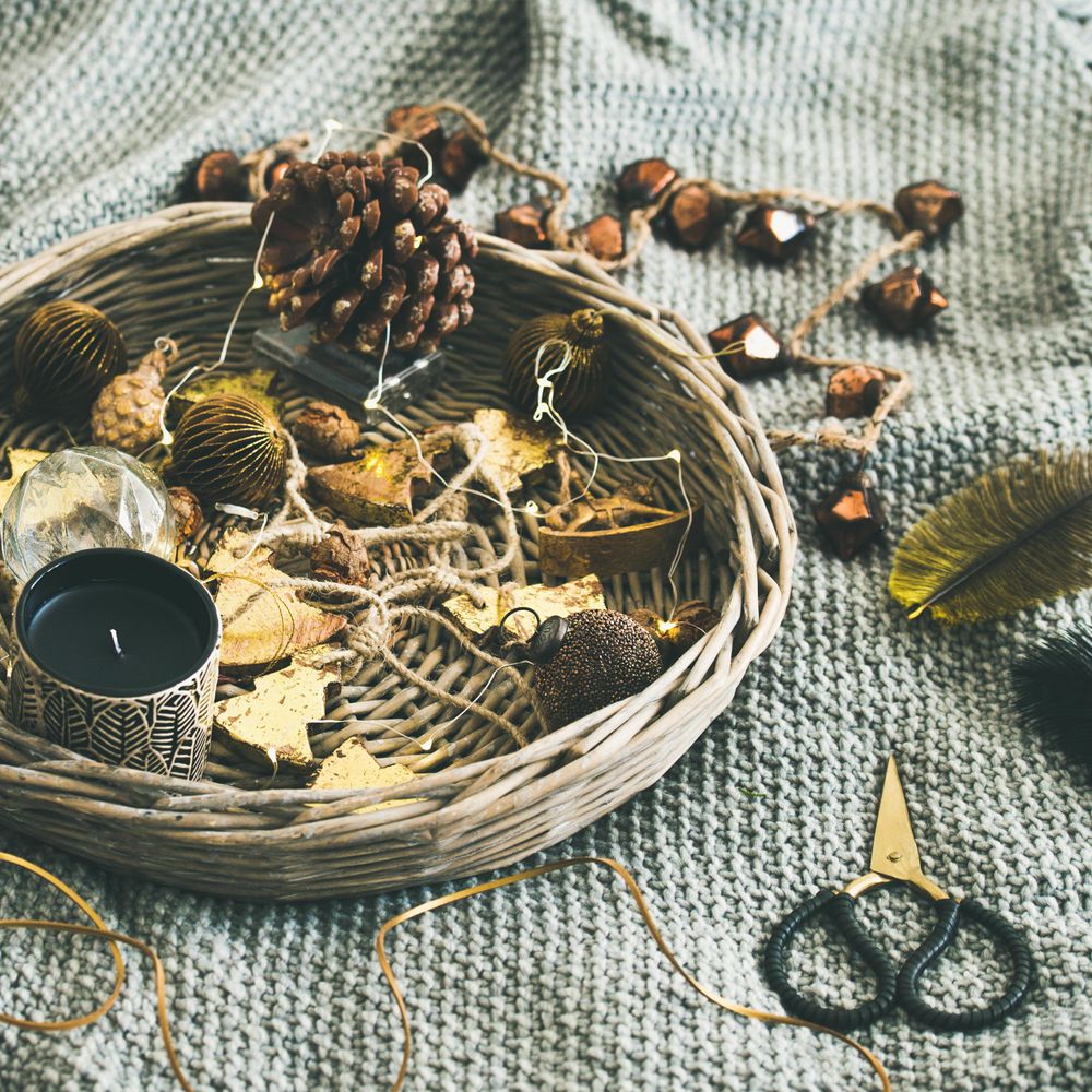 Basket of Christmas decorations on blanket