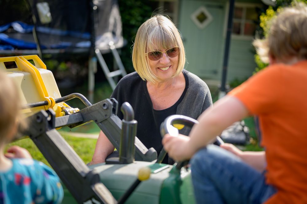 Woman with children down with gardening equipment