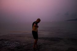Man at dusk in shallow water