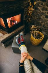 Man resting warmly by the fireplace