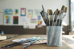 Close up of painting brushes in studio of artist..