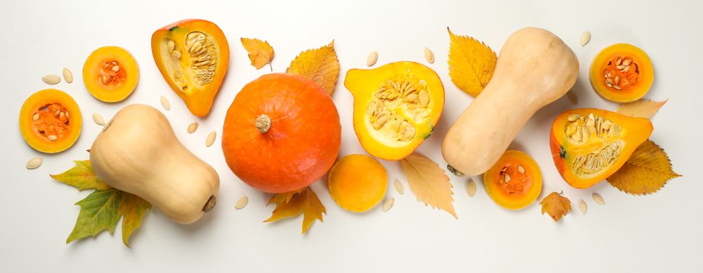 Composition with pumpkin, seeds and leaves on blank background
