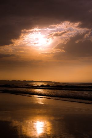 Beautiful evening sky over waving sea and shore