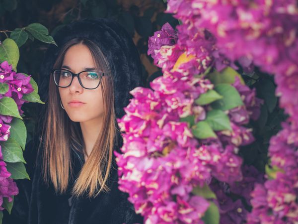 Woman on background of stunning violet flowers