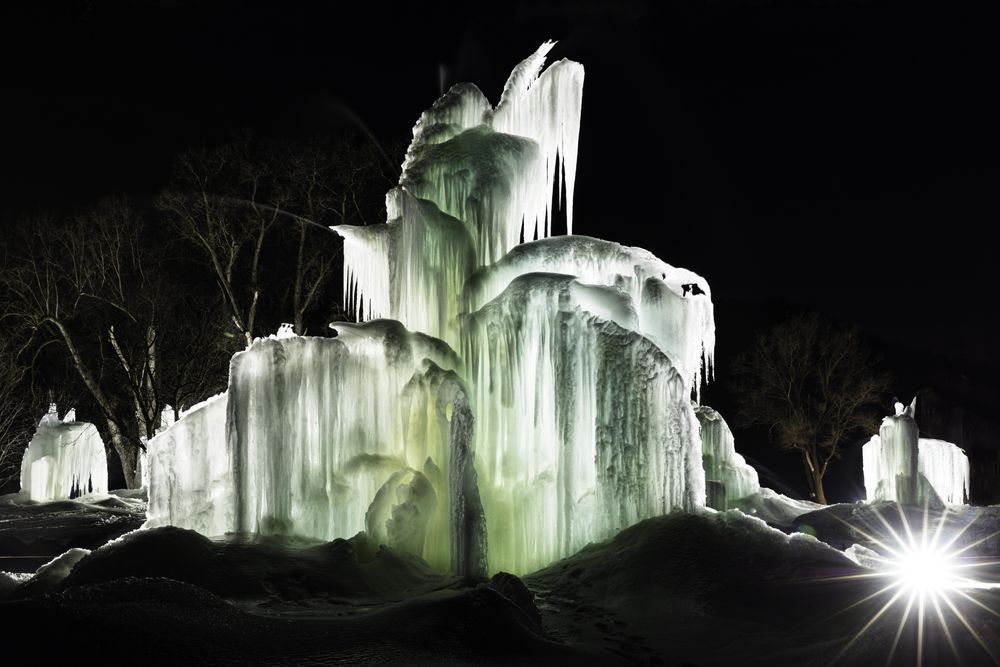 Lit up icicle structures at a snowy winter park