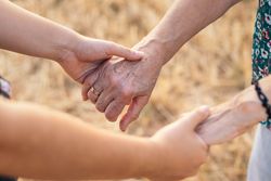 Two Generations Of Women Hold Hands: Grandmother And Granddaughter Holding Hands