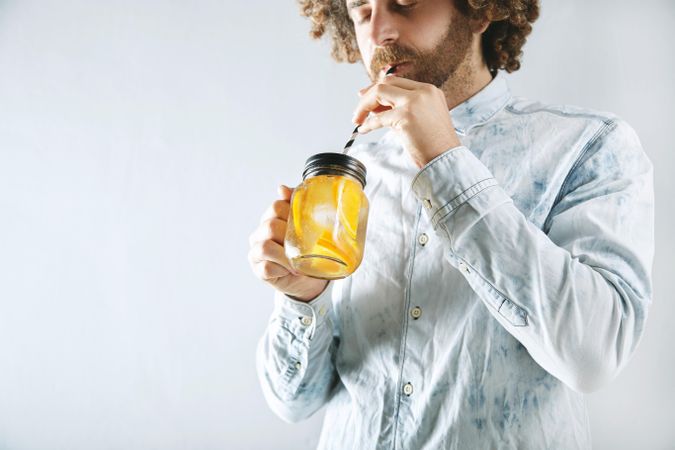 Man drinking orange infused water