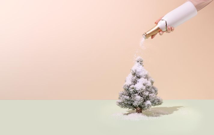 Champagne bottle pouring snow on the Christmas tree