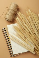 Notebook with dried flowers, yarn, pencils