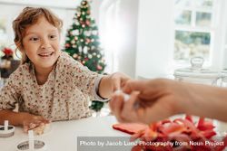Little girl making cookies for Christmas with adult 4mWvkQ