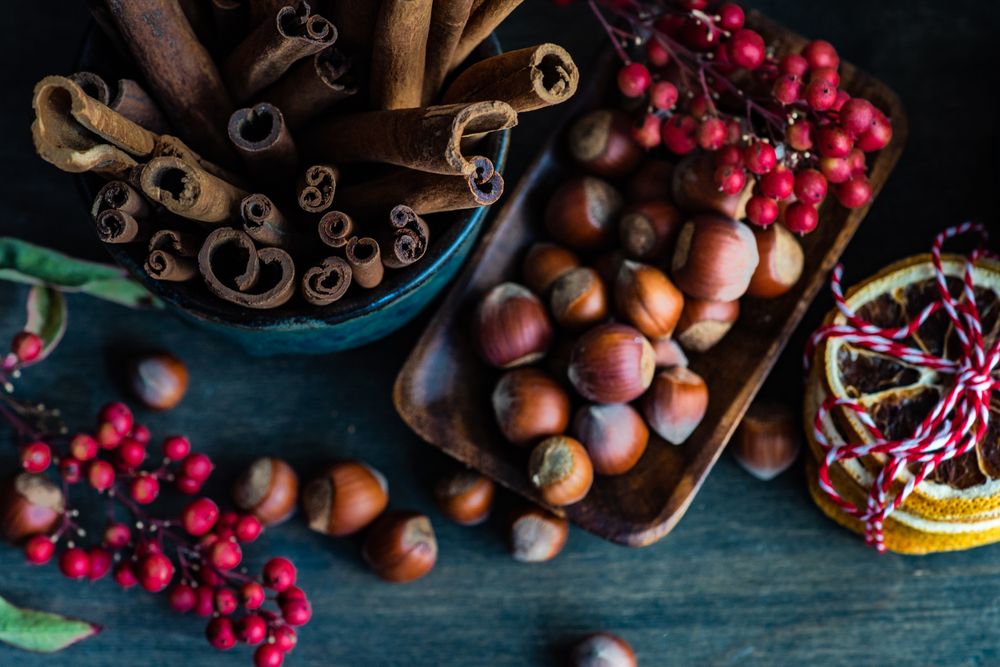 Top view of hazelnuts and cinnamon sticks on table