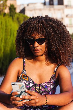 Stylish  woman using smartphone on street