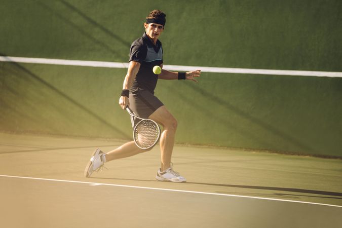 Tennis player playing on a hard court
