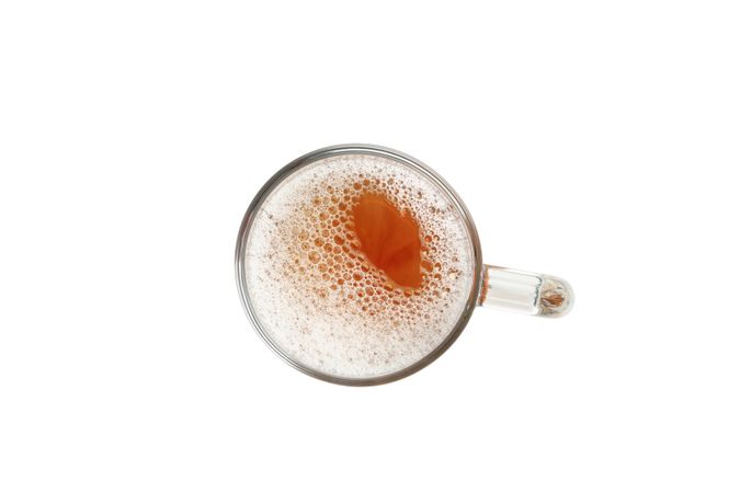 Glass of beer isolated on light background