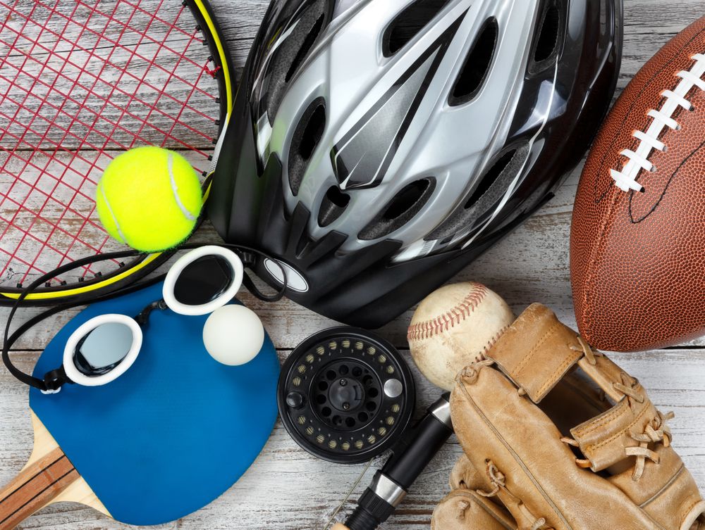 Used sports equipment placed on rustic wooden background