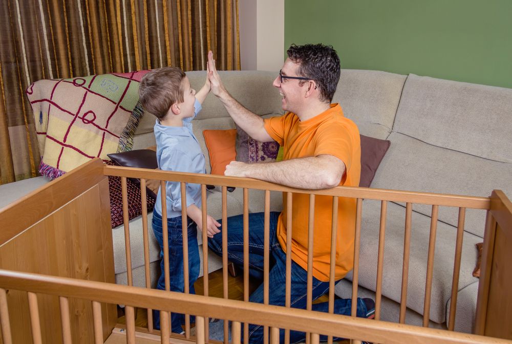 Father and son giving five for success in a home work