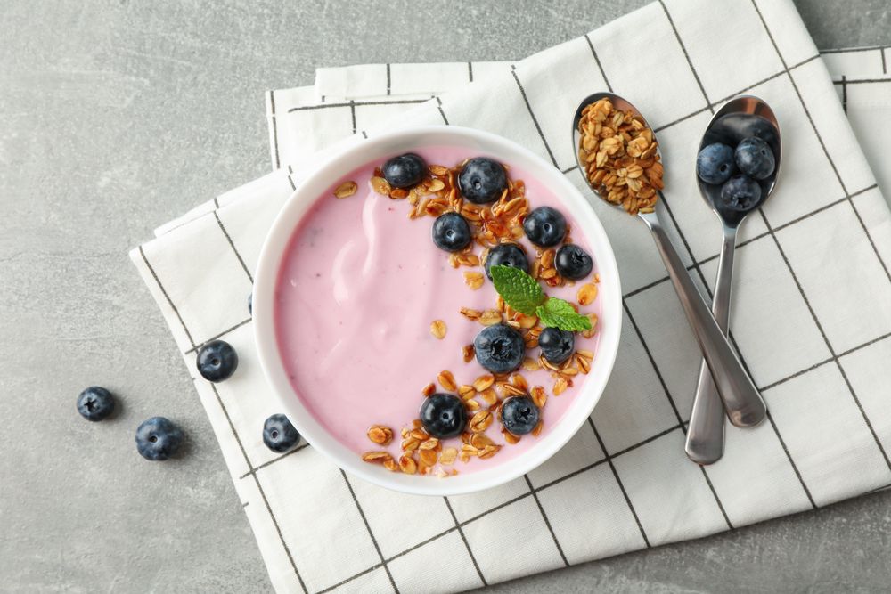 Composition with tasty yogurt on grey background, space for text