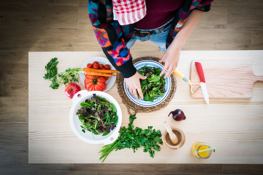Woman preparing vegetable salad