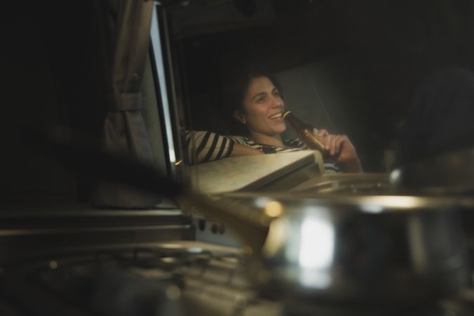 Reflection of woman drinking from bottle