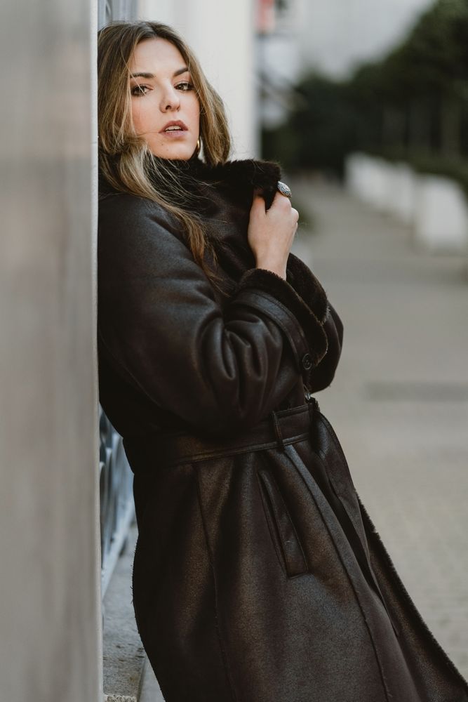 female standing on city street