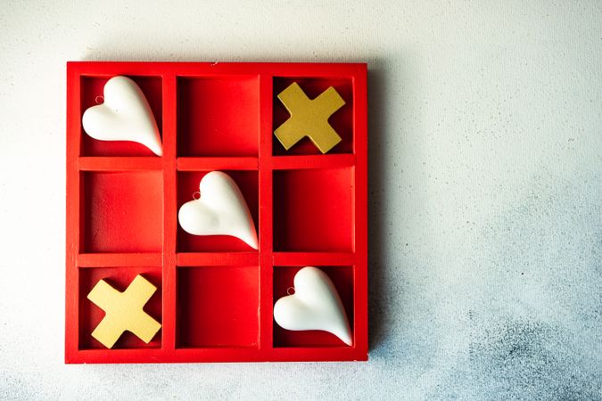 St. Valentine day card concept with heart shapes in game of tic-tac-toe