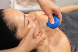 Female receiving facial treatment in salon