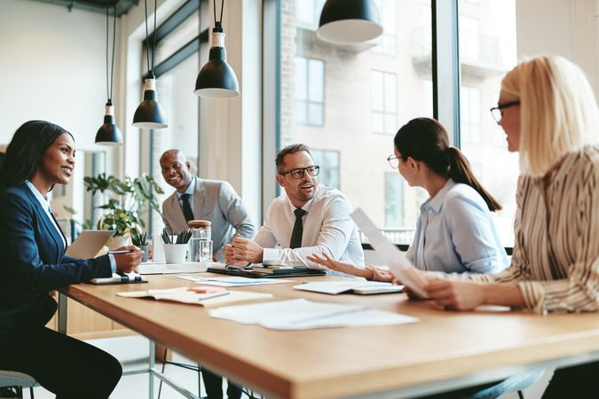 Group of business people working together in a bright office