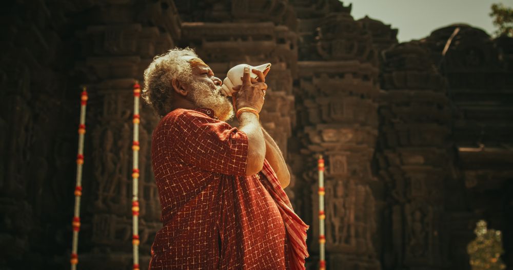 Portrait of a Older Hindu Monk Looking at the Camera and Smiling in an Ancient Temple.