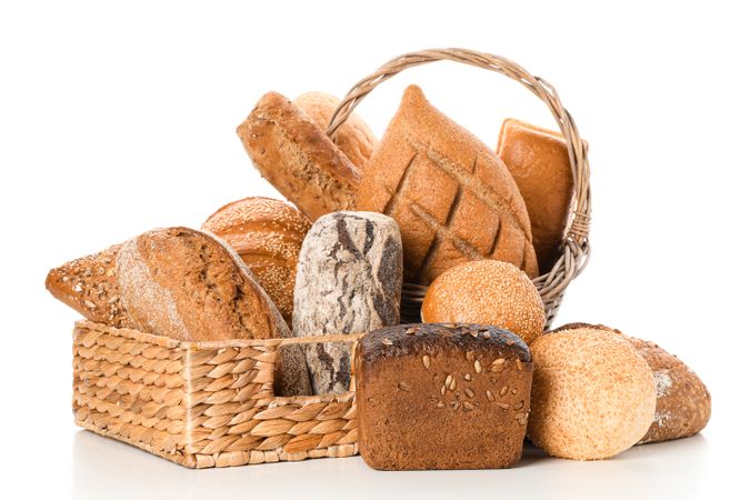 Bakery products in straw basket isolated on blank background
