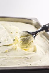 Scooping out a ball of pistachio ice cream