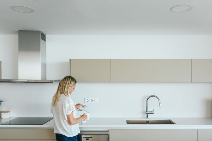Woman making tea in kitchen