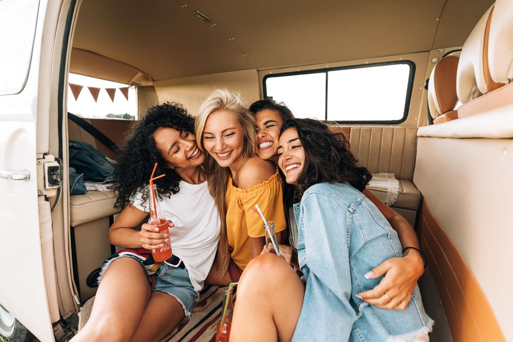 Group of women hugging in the back of a van