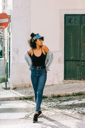 Happy female walking on crosswalk