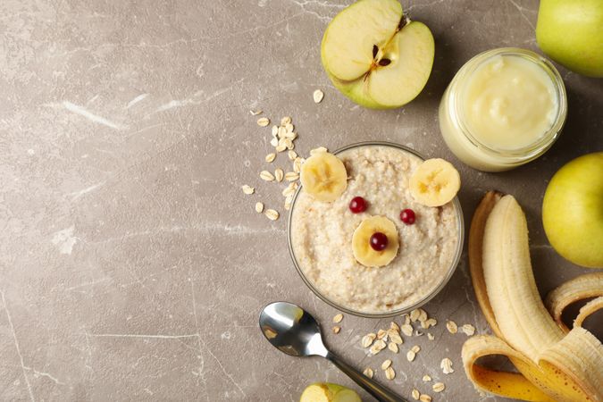 Composition with baby food on gray background, top view